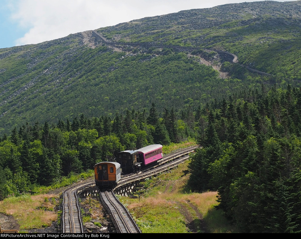 MWCR M7 (orange locomotive - heading up the mountain) passes MWCR 2, (Black locomotive), which is heading downhill